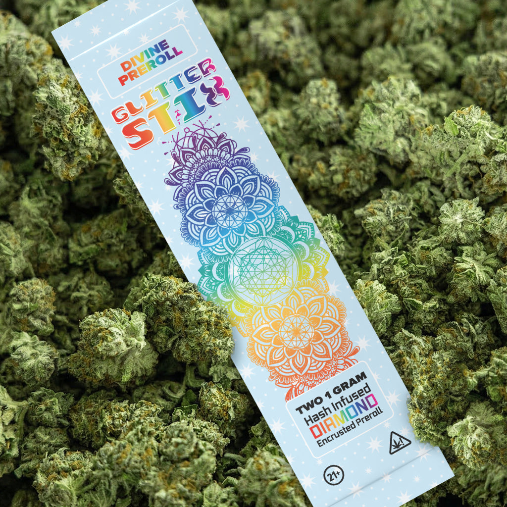 Colorful packaging of a cannabis product on a bed of green cannabis buds.
