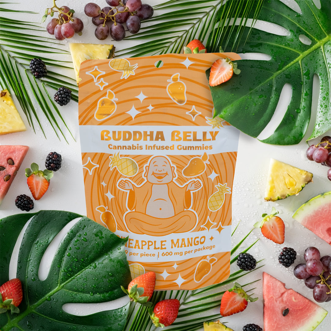 Buddha Belly cannabis-infused gummies package with tropical fruits and leaves on a white background