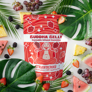 Buddha Belly Strawberry cannabis-infused gummies packaging surrounded by fruits and leaves.